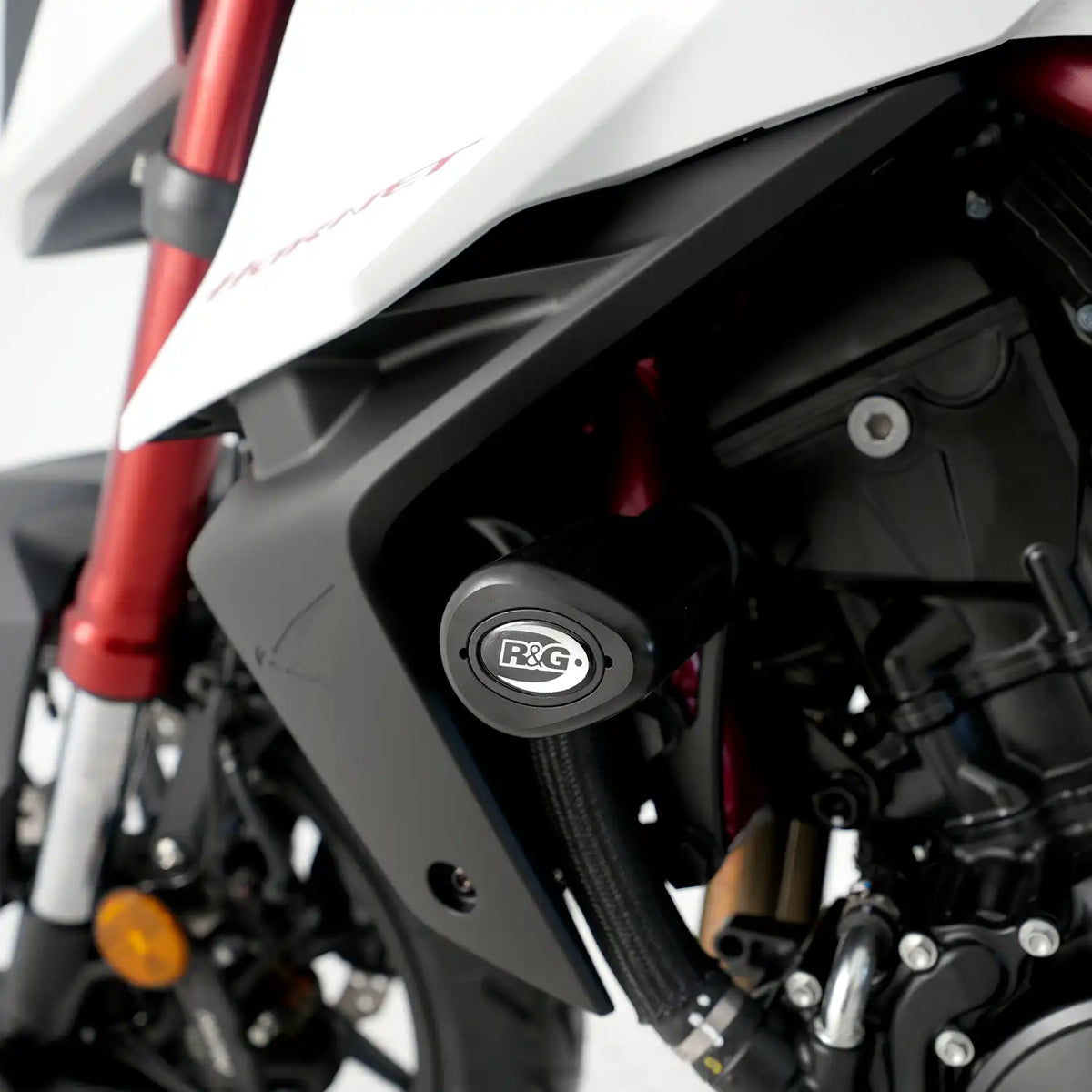 Detalle de Tope de Caída R&G Aero Style con bobbin aerodinámico negro instalado en chasis Honda CB750 Hornet